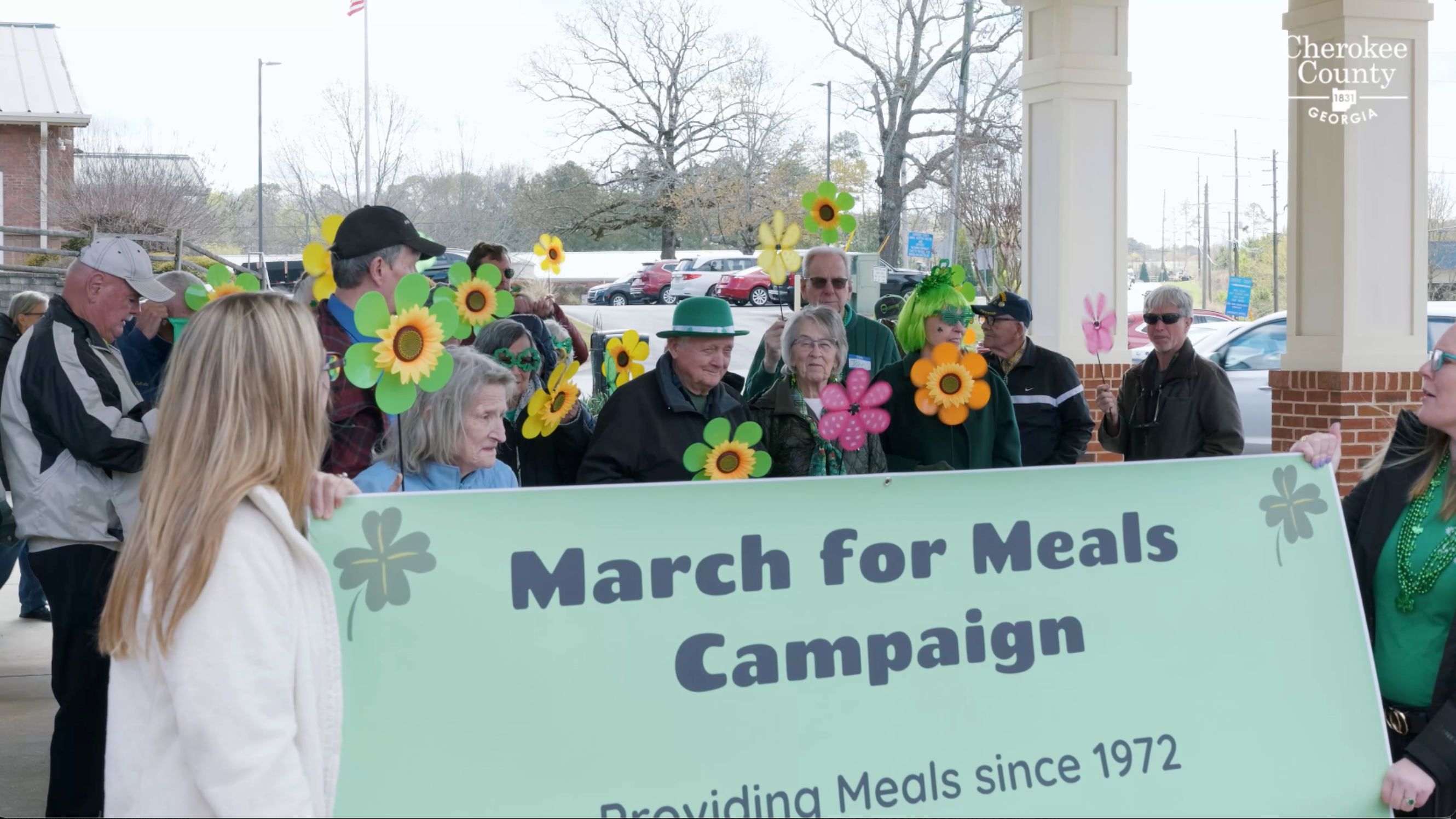 Image of 10+ senior citizens holding sign that reads "March for Meals Campaign"